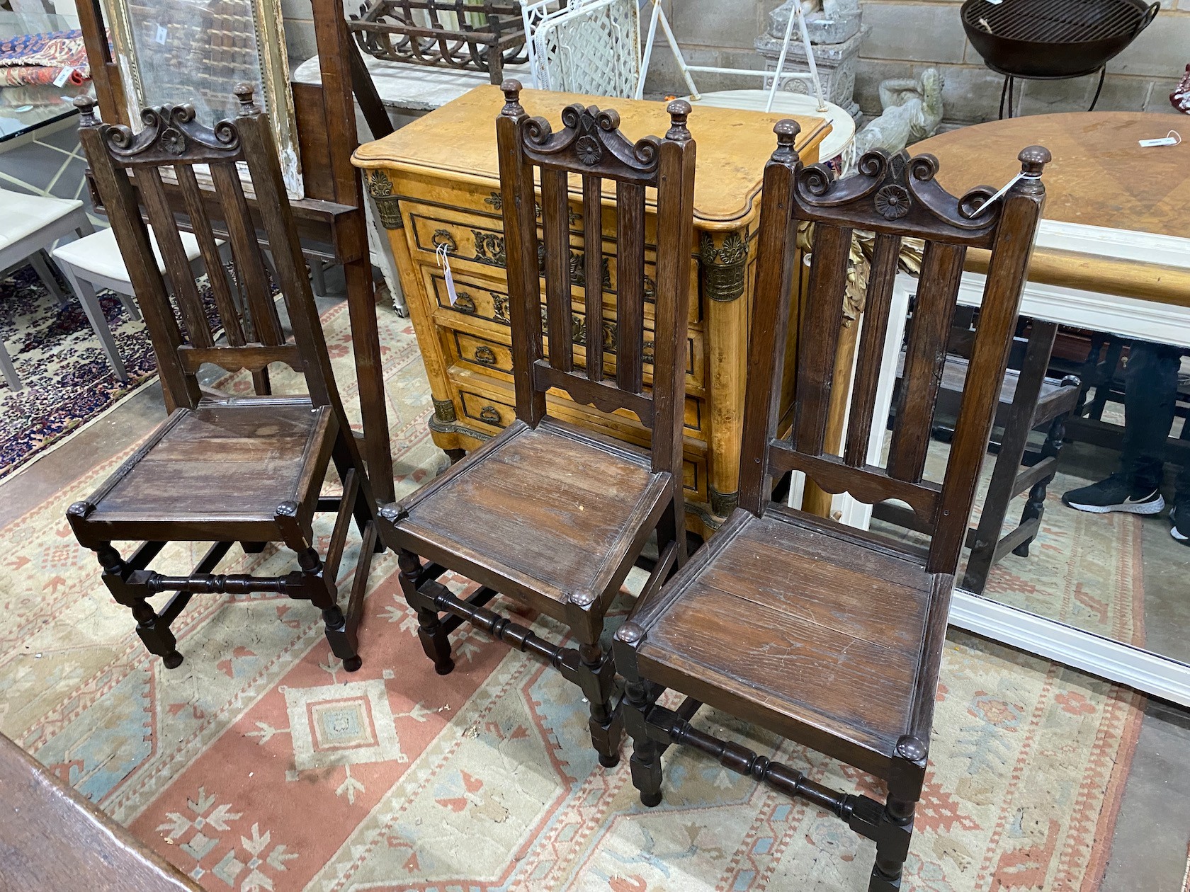 A set of eight 18th century style oak wood seat dining chairs two with arms